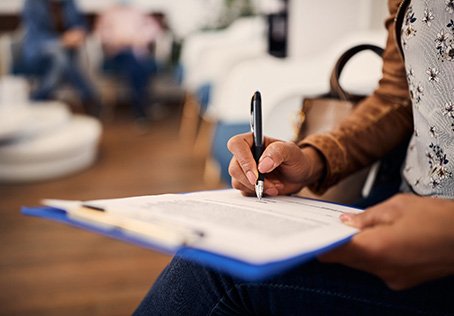 Patient filling out forms in lobby