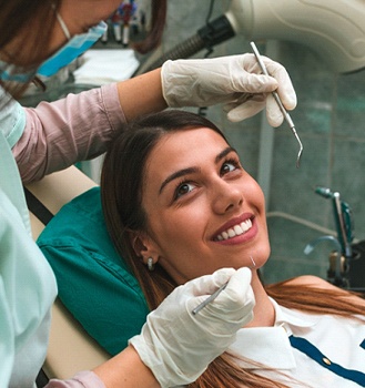 A young woman having her teeth checked at the dentist office