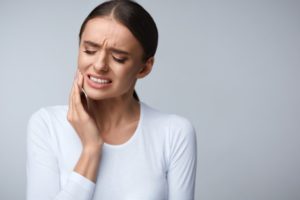 A woman experiencing a toothache.