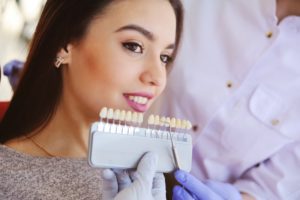 woman smiling beside porcelain veneers