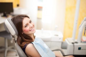 A woman smiling at her dental appointment.