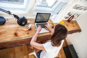 A woman working on a laptop.