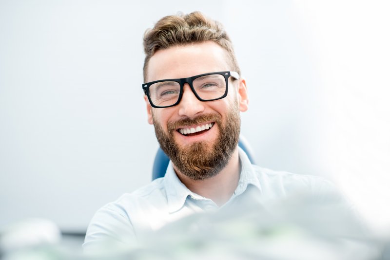 young man smiling in dentist chair