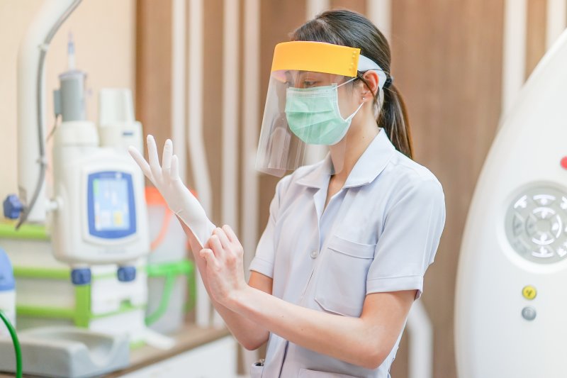 Dentist in Burleson putting on PPE