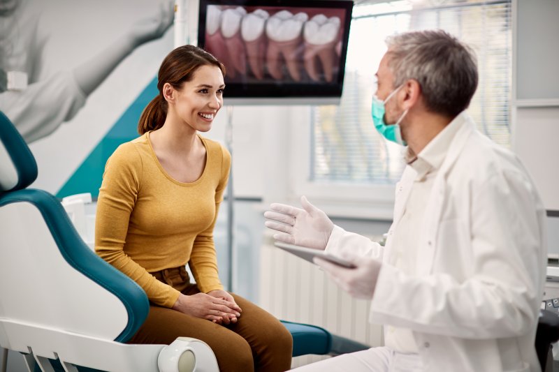 young woman talking with dentist