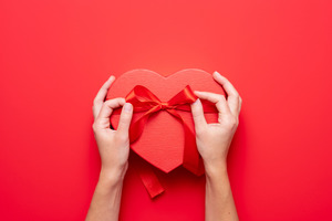 Tying a bow on a heart-shaped box