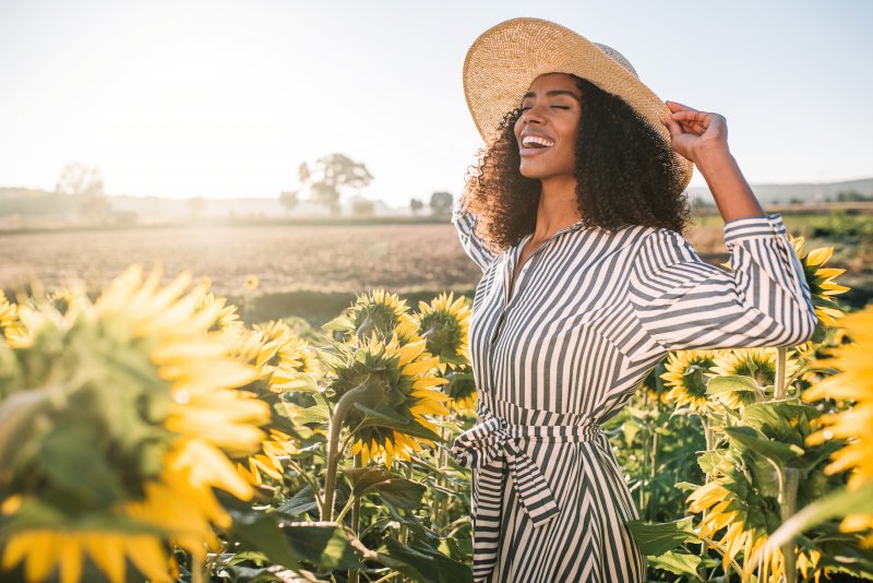 smiling woman lying in a field