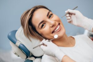 Woman smiling after receiving a cosmetic dental treatment
