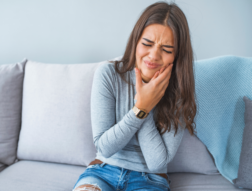 Woman holding jaw in pain