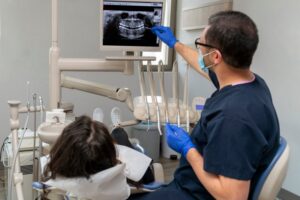 Dentist pointing to a dental X-ray